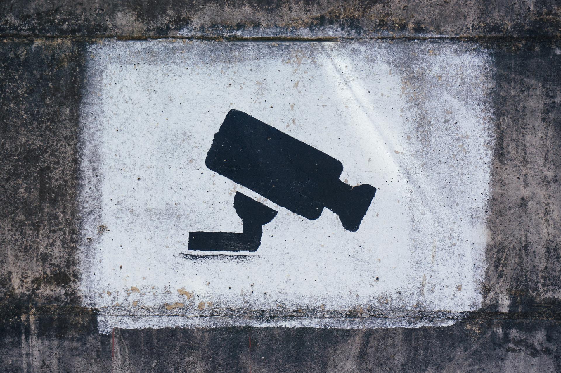 A security camera image painted on a wall