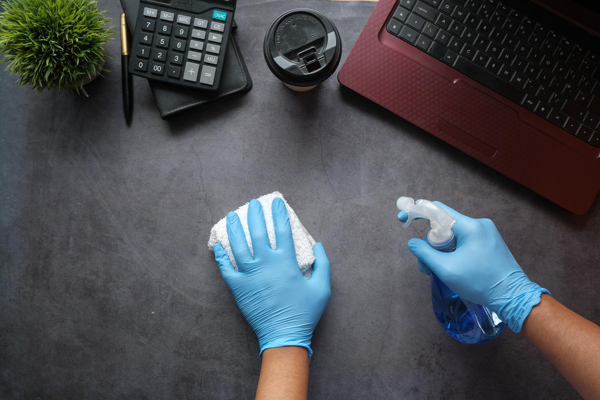 A person cleaning a desk